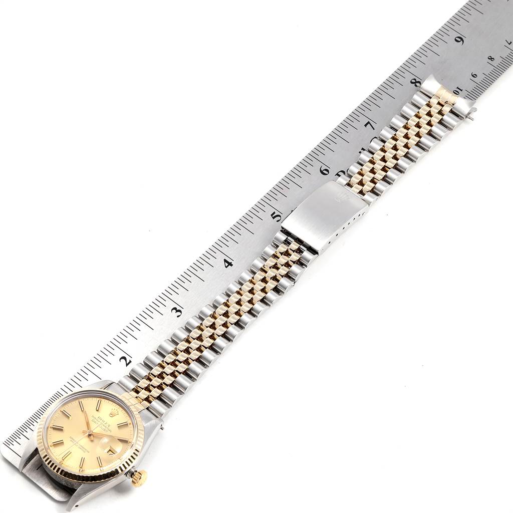 The image shows a Rolex Vintage Collection 16013 Men's Stainless Steel Champagne Dial 16013 Men's Stainless Steel Champagne Dial watch laid flat next to a ruler, displaying its bracelet and face.