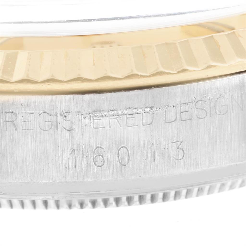 The image shows the side view of the Rolex Vintage Collection 16013 Men's Stainless Steel Champagne Dial 16013 Men's Stainless Steel Champagne Dial watch focusing on the bezel and engraved model number 16013.