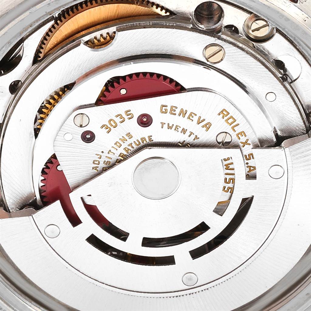 A close-up of the internal mechanism of a Vintage Collection Rolex watch, showing gears and the movement components.