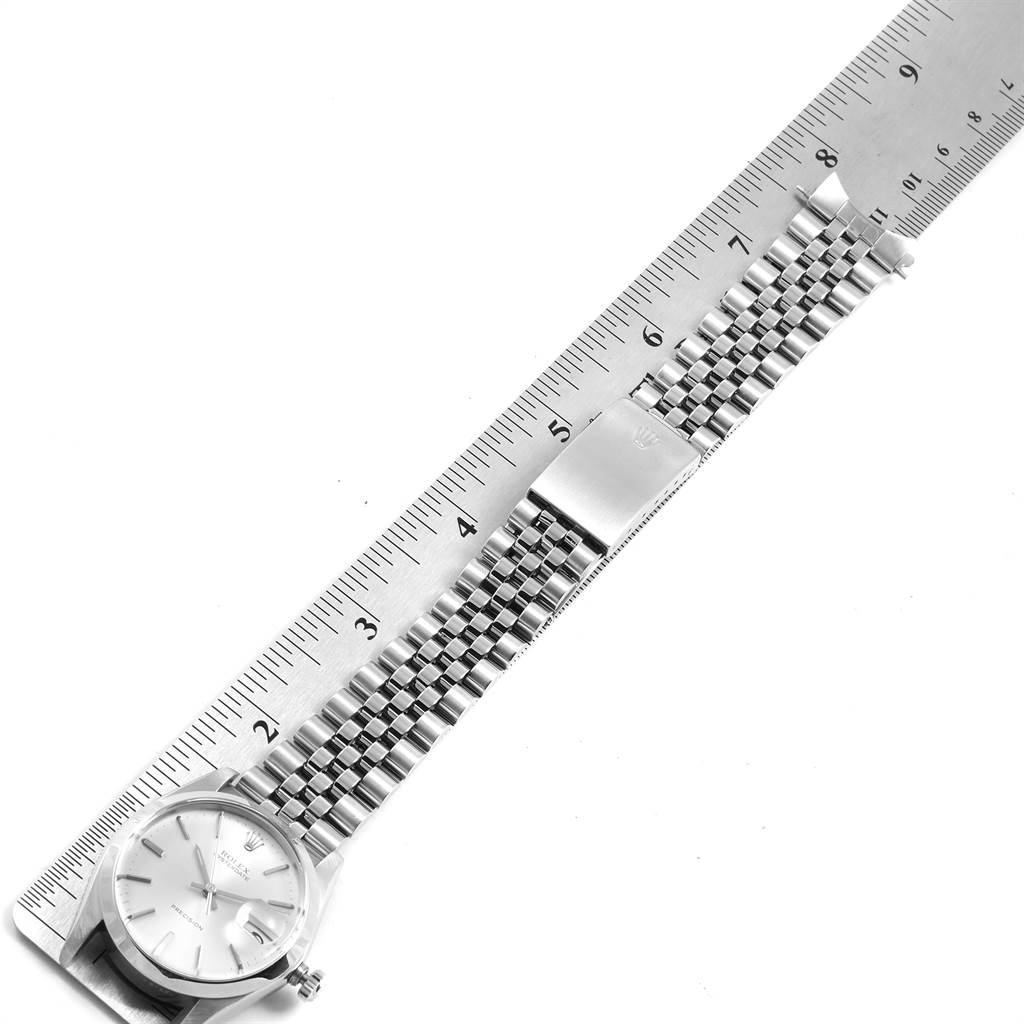 The image shows a Rolex Vintage Collection 6694 Men
s Stainless Steel Silver Dial 6694 Men
s Stainless Steel Silver Dial watch laid flat with the bracelet extended alongside a ruler for measurement.