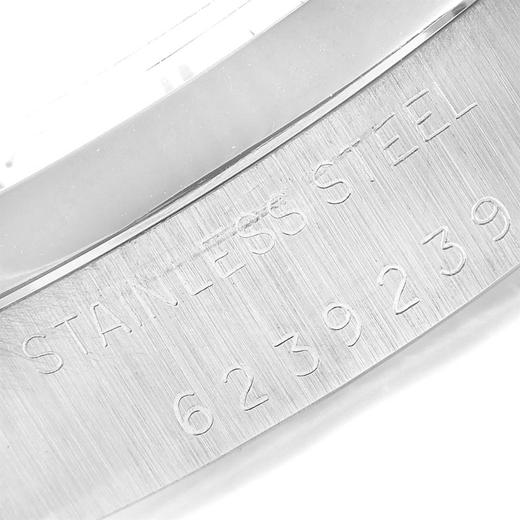 This image shows a close-up of the case back edge for a Vintage Collection model by Rolex, displaying the stainless steel engraving and serial number.