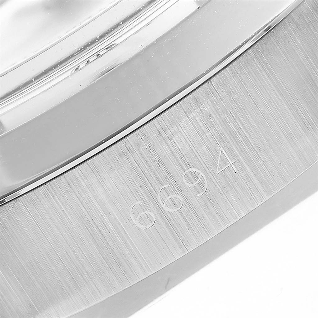 This is a close-up angle showing the engraved serial number on the bezel of the Rolex Vintage Collection 6694 Men's Stainless Steel Silver Dial 6694 Men's Stainless Steel Silver Dial model watch.