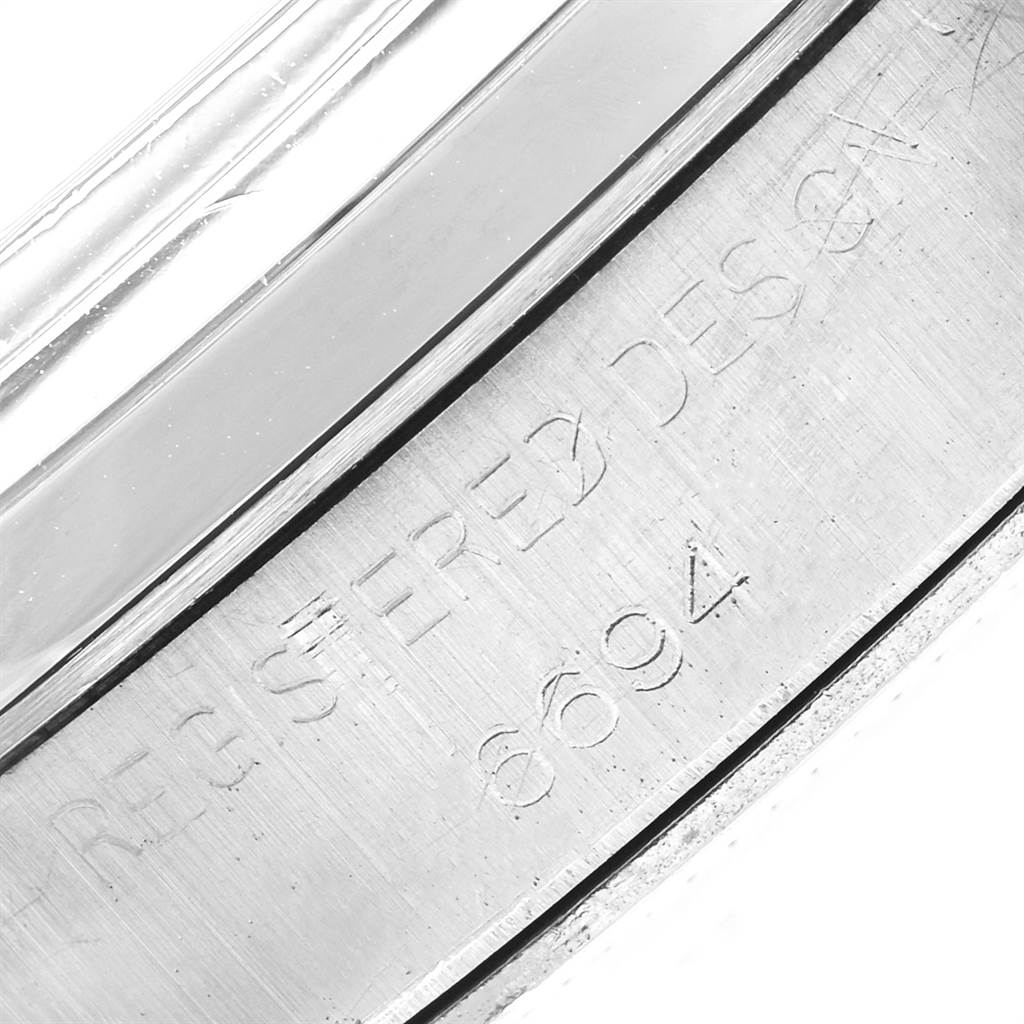 The image shows an engraved part of the casing for the Rolex Vintage Collection 6694 Men's Stainless Steel Black Dial 6694 Men's Stainless Steel Black Dial watch, featuring the serial and model numbers.