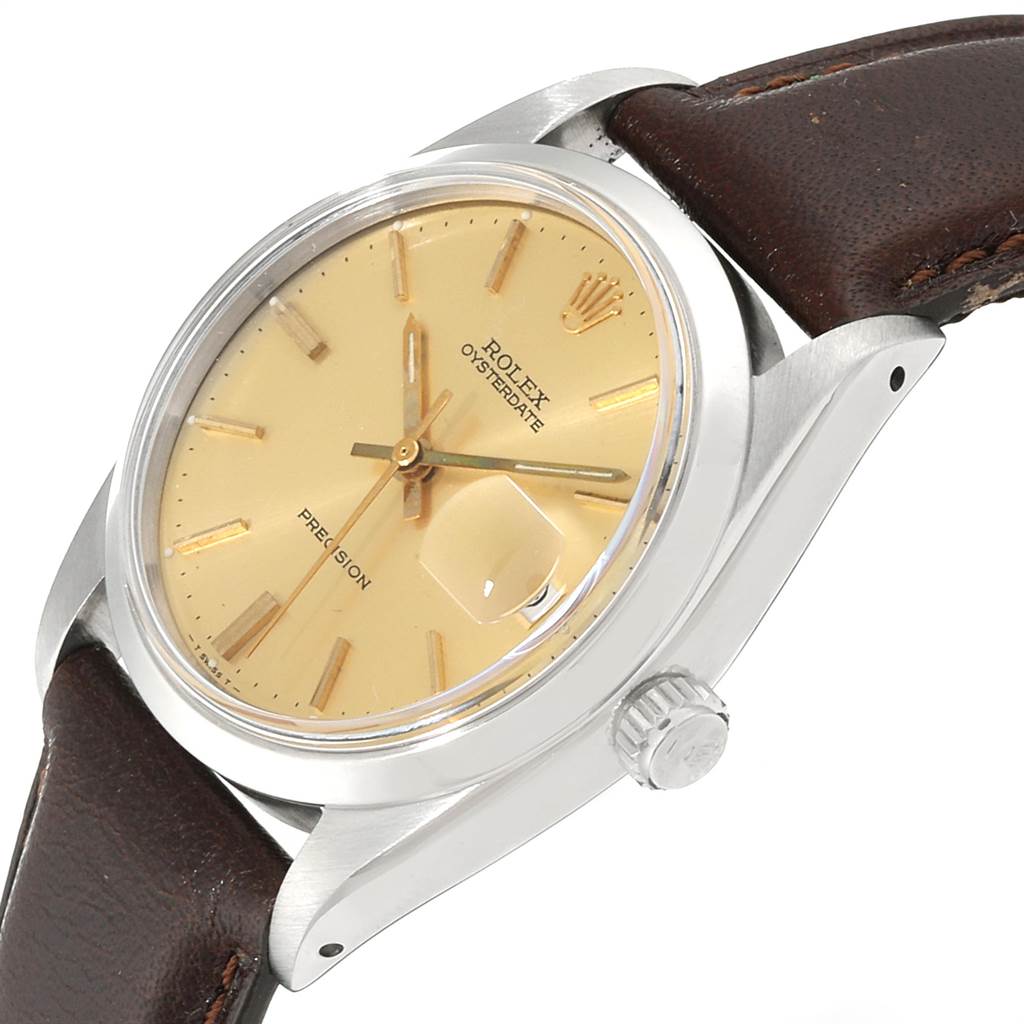 This image shows a three-quarter view of a Rolex Vintage Collection 6694 Men's Stainless Steel Champagne Dial 6694 Men's Stainless Steel Champagne Dial watch, highlighting the face, crown, and part of the leather strap.