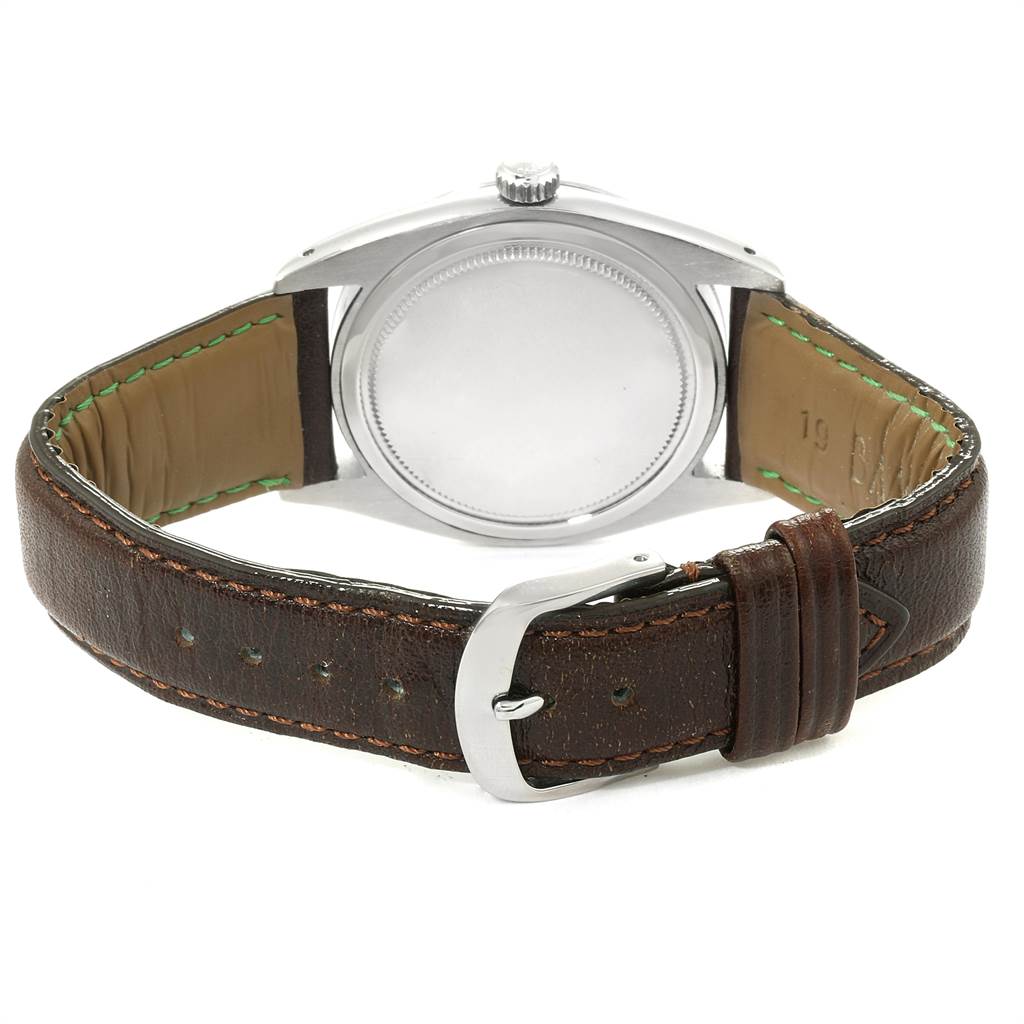 This image shows the back side of a Rolex Vintage Collection 6694 Men's Stainless Steel Champagne Dial 6694 Men's Stainless Steel Champagne Dial model watch with its leather strap and buckle visible.