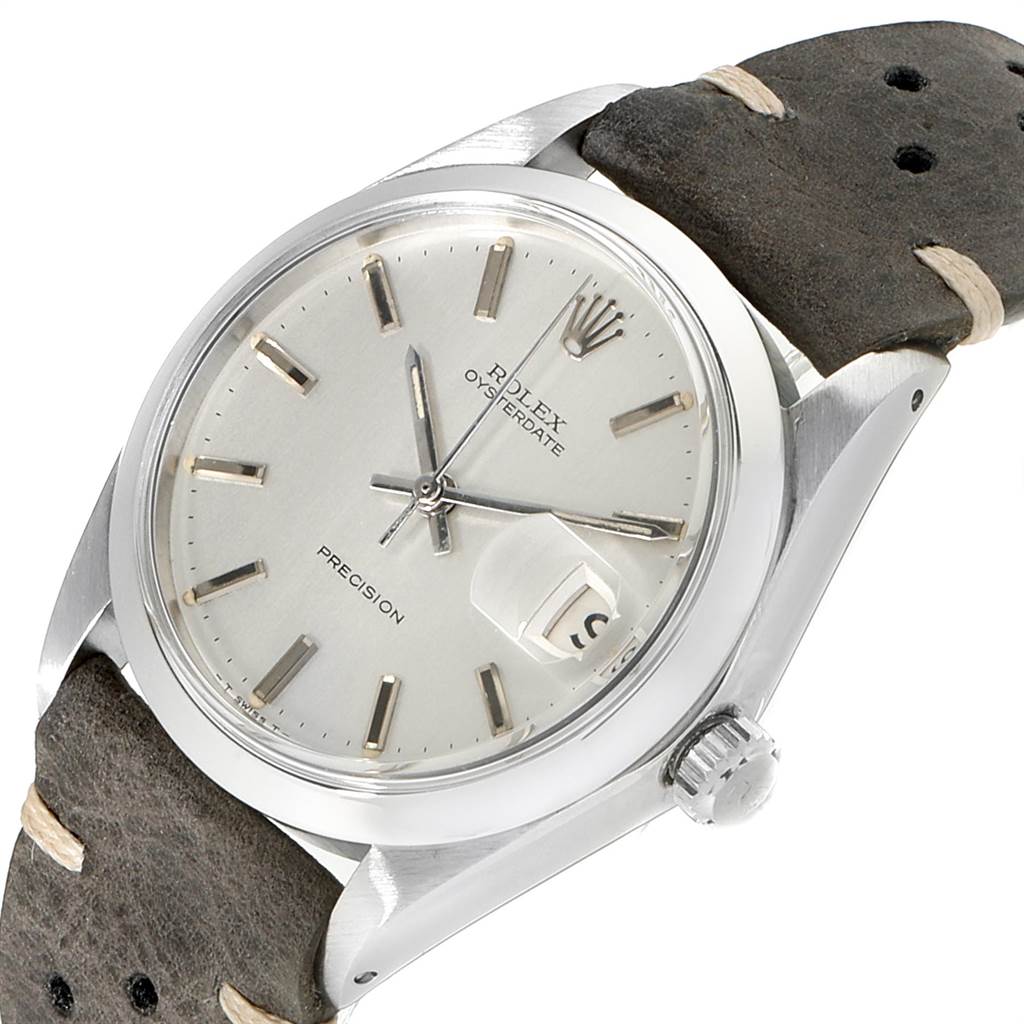 This image shows a tilted view of a Rolex Vintage Collection 6694 Men's Stainless Steel Silver Dial 6694 Men's Stainless Steel Silver Dial Oysterdate watch, highlighting its dial, case, crown, and leather strap.