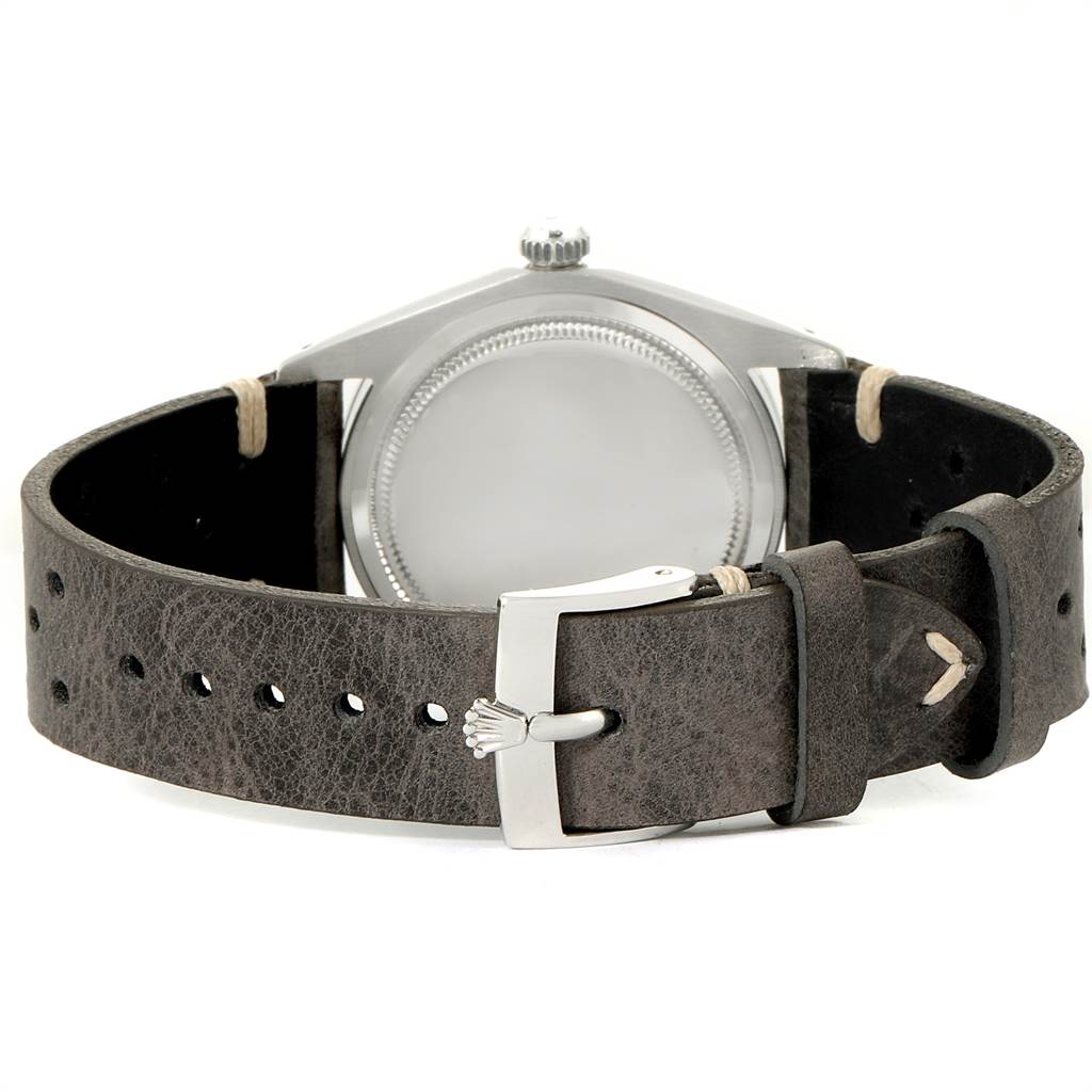 This image shows the back of a Rolex Vintage Collection 6694 Men's Stainless Steel Silver Dial 6694 Men's Stainless Steel Silver Dial watch, highlighting the case back and leather strap with buckle.