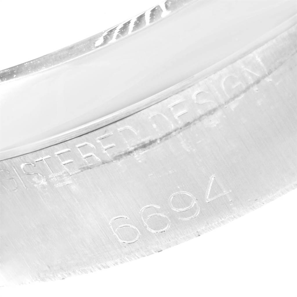 This close-up image shows the model number "6694" engraved on the casing of a Rolex Vintage Collection 6694 Men's Stainless Steel Black Dial 6694 Men's Stainless Steel Black Dial watch.