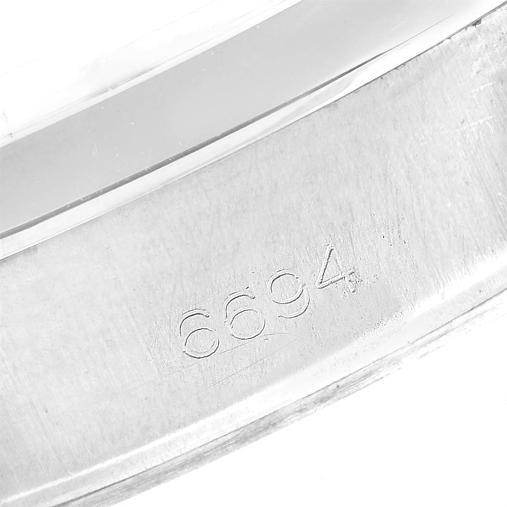 This image shows an engraved model number "6694" on the inner case of the Vintage Collection model by Rolex.