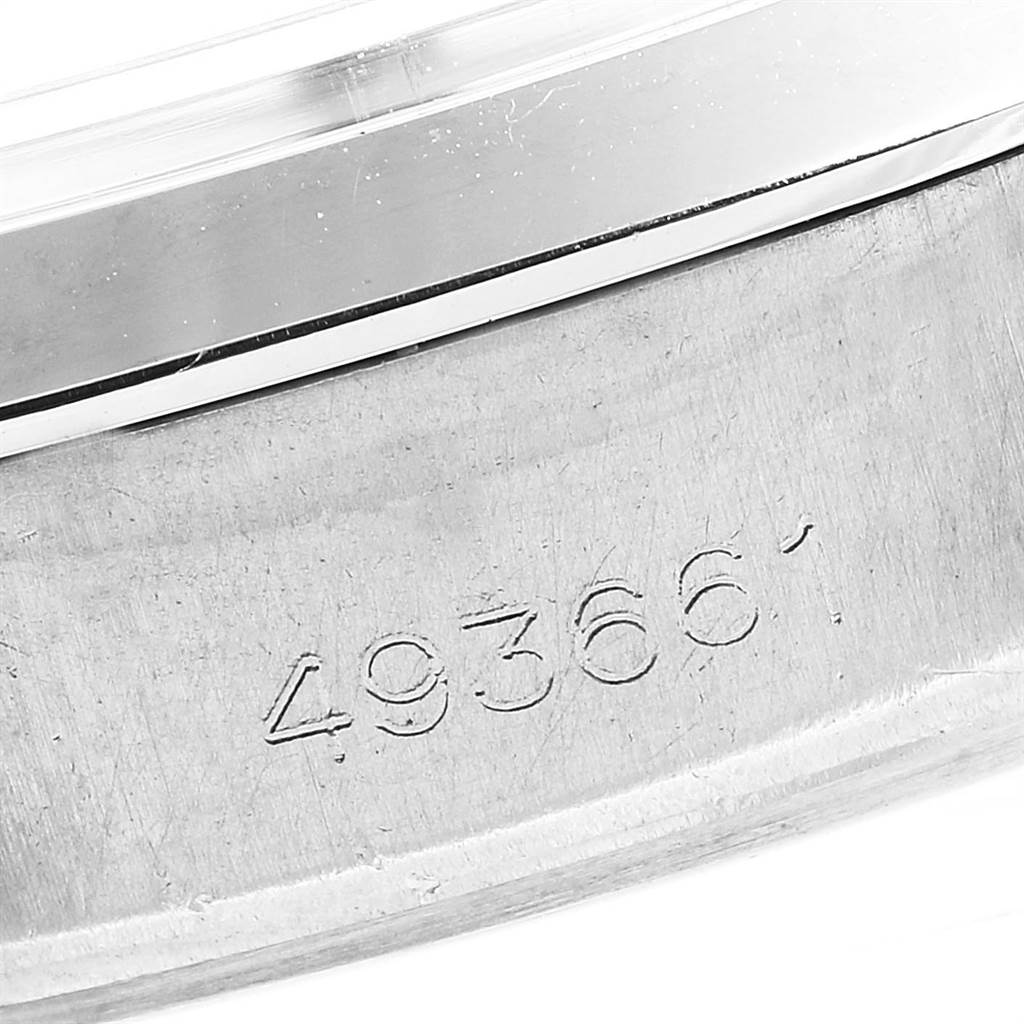 This image shows a close-up of the serial number and part of the bezel of a Rolex Vintage Collection 6694 Men's Stainless Steel Champagne Dial 6694 Men's Stainless Steel Champagne Dial watch.