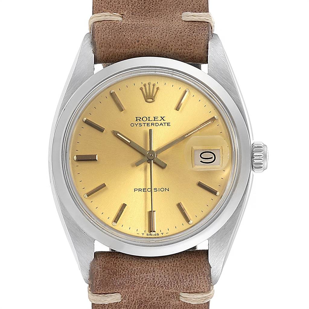 The image shows a front view of a Rolex Vintage Collection 6694 Men's Stainless Steel Champagne Dial 6694 Men's Stainless Steel Champagne Dial Oysterdate watch with a gold dial, leather strap, and date display.