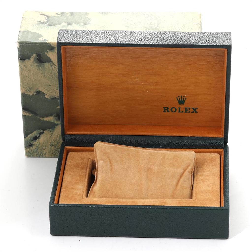 This image shows an open Rolex Vintage Collection 16013 Men's Stainless Steel Blue Dial 16013 Men's Stainless Steel Blue Dial watch box, displaying its interior cushion and wood finish.