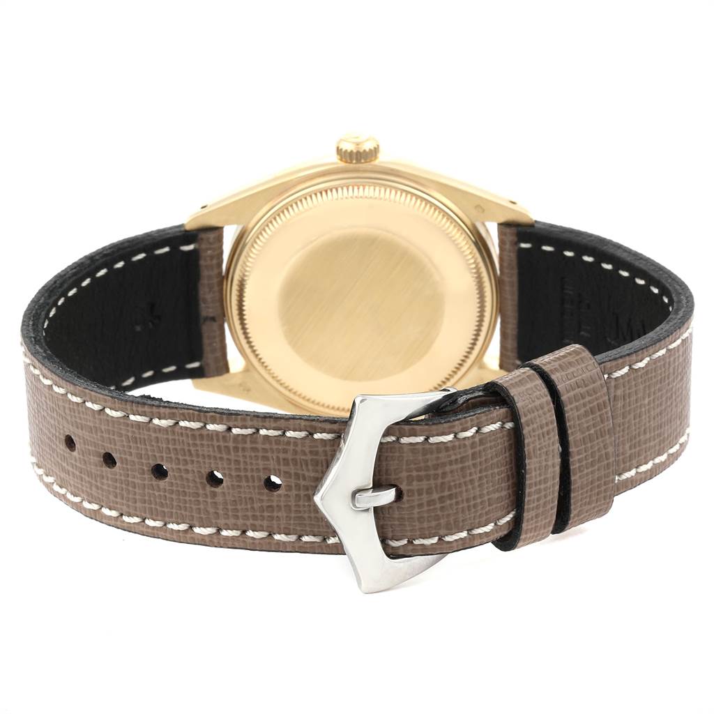This is a rear view of the Rolex Vintage Collection 1503 Men's Yellow Gold Brown Dial 1503 Men's Yellow Gold Brown Dial watch, showing the caseback and leather strap with a buckle.