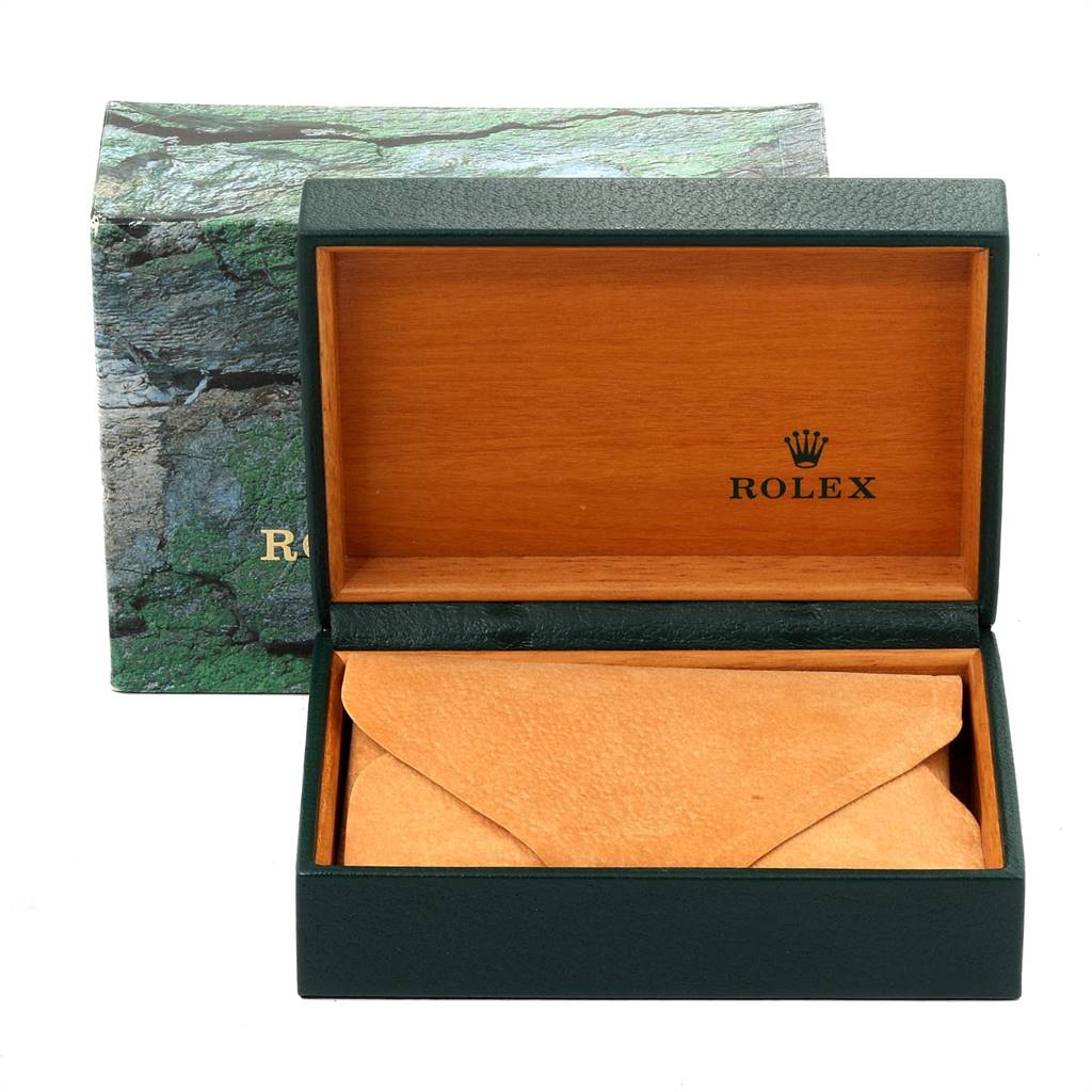 The image shows an open green Rolex box with a beige envelope inside, part of the Vintage Collection model.