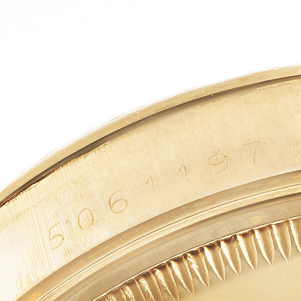 This image shows a close-up of the engraved serial number and parts of the bezel and case of the Vintage Collection model by Rolex.