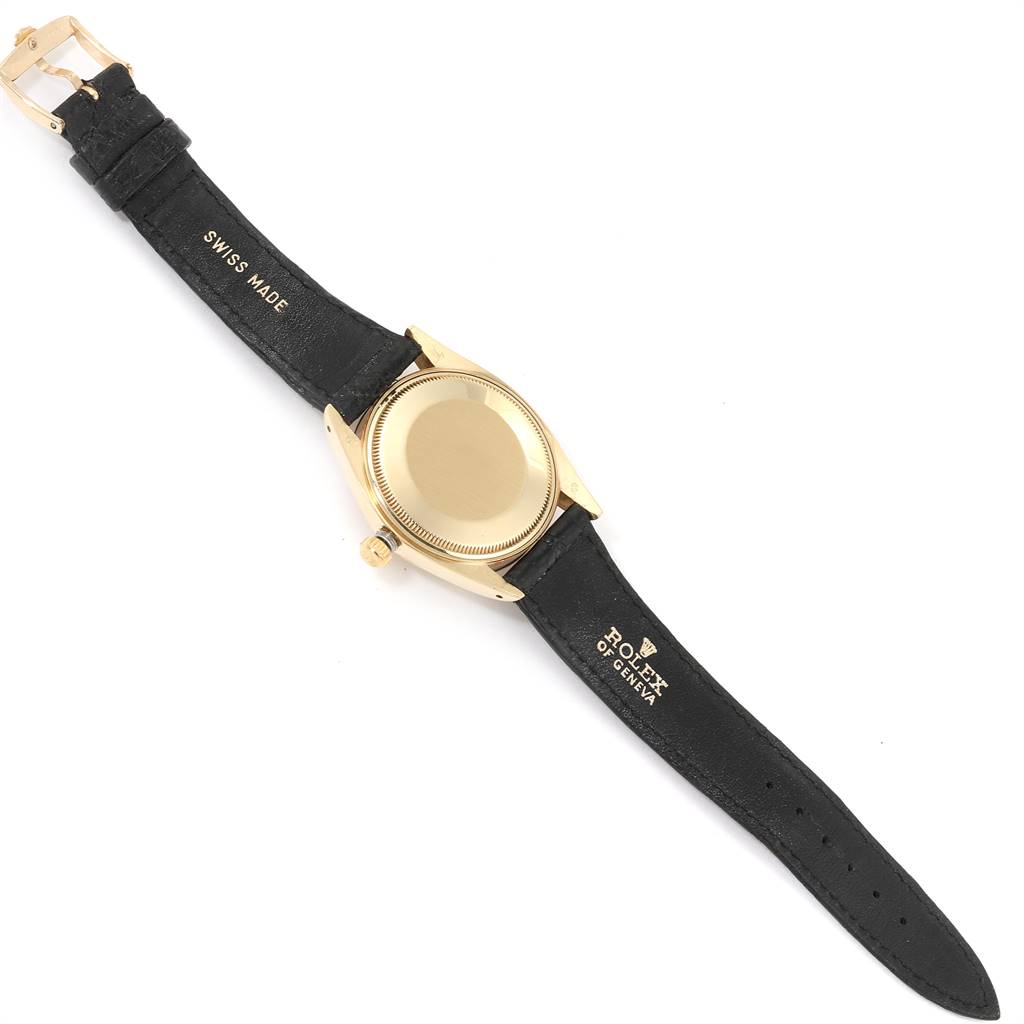 The Vintage Collection Rolex watch is shown from the backside, displaying the case back, crown, and leather strap.