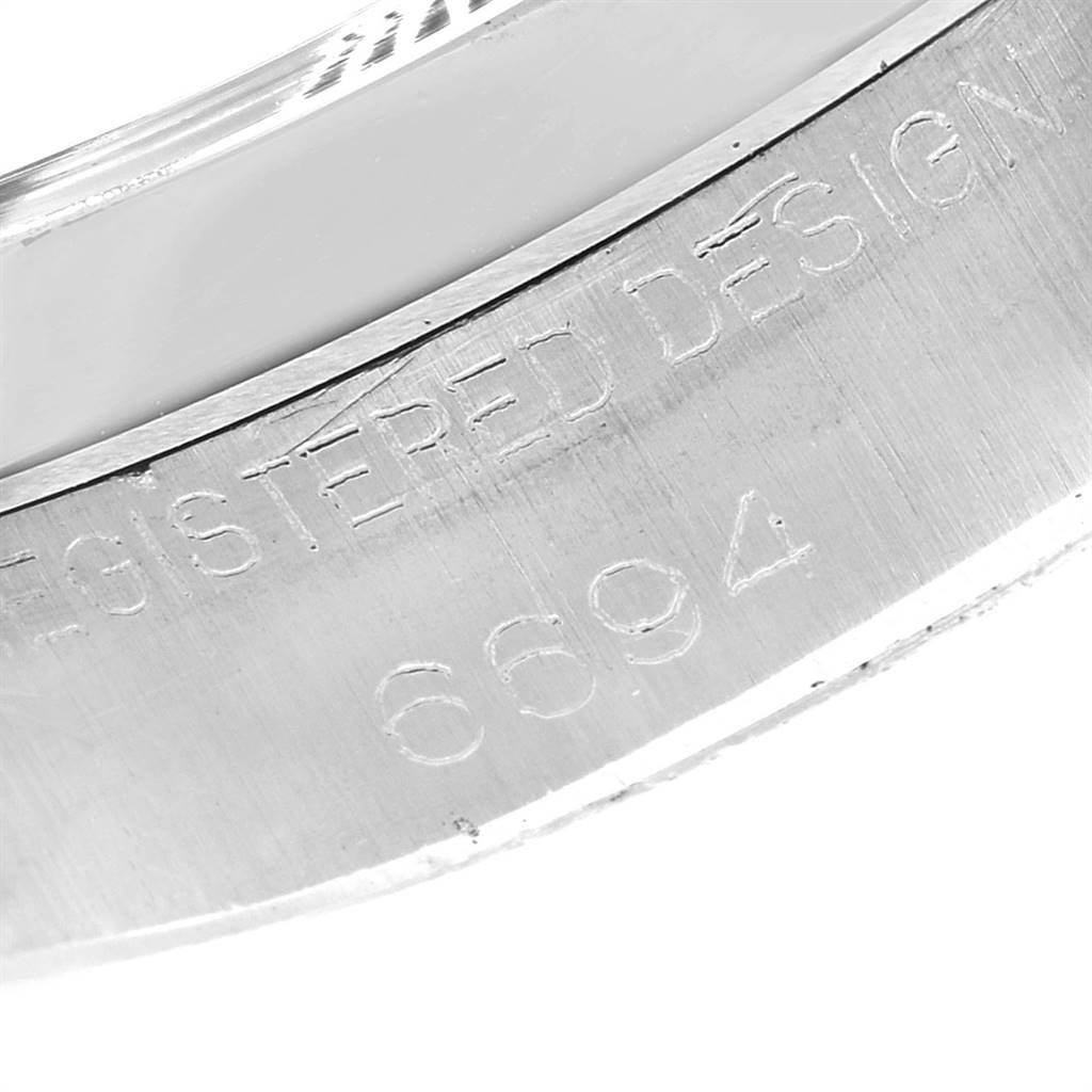 The image shows an engraved serial number and text on the caseback of a Rolex Vintage Collection 6694 Men's Stainless Steel Black Dial 6694 Men's Stainless Steel Black Dial model watch.