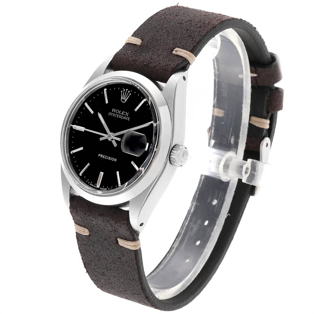 The image shows a side angle of the Rolex Vintage Collection 6694 Men's Stainless Steel Black Dial 6694 Men's Stainless Steel Black Dial model, highlighting the black dial, silver casing, and brown leather strap.