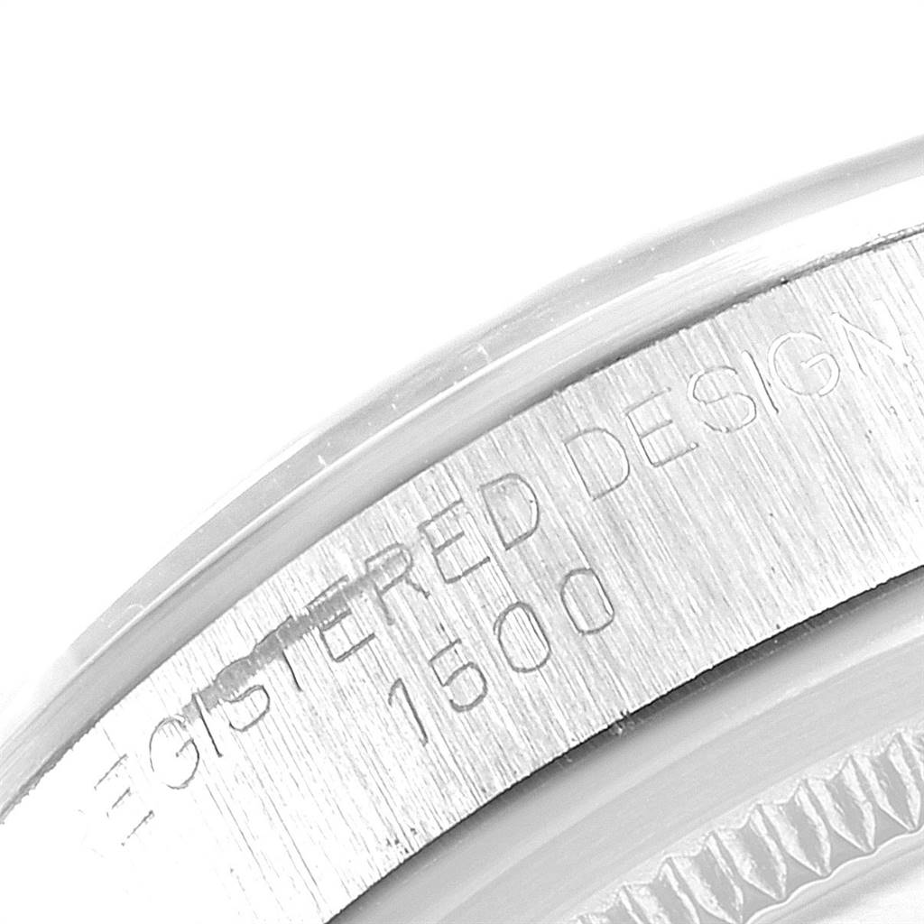 This close-up image shows the engraved serial number and part of the bezel of a Vintage Collection Rolex watch model 1500.