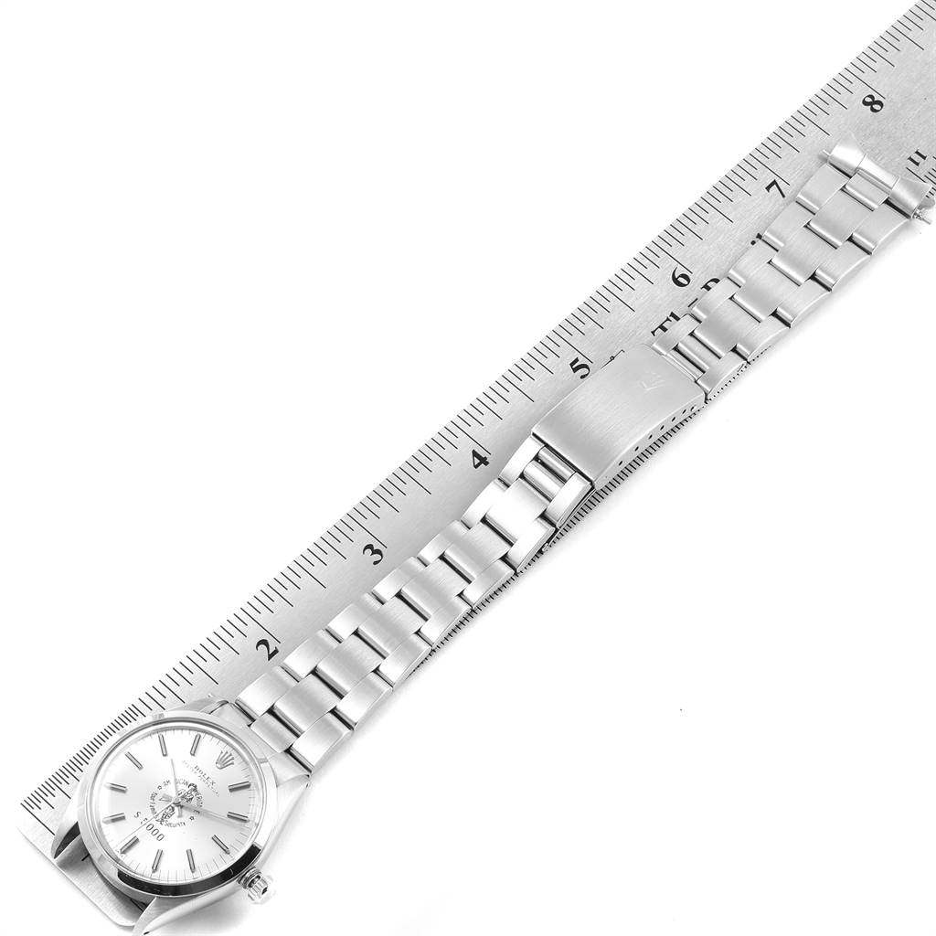 The Rolex Vintage Collection 1002 Men's Stainless Steel Silver Dial 1002 Men's Stainless Steel Silver Dial model is shown laid flat next to a ruler, highlighting its full bracelet and dial.