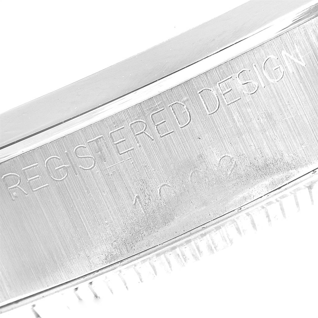 This image shows a close-up of the engraved case side of the Rolex Vintage Collection 1002 Men's Stainless Steel Silver Dial 1002 Men's Stainless Steel Silver Dial model with "REGISTERED DESIGN" visible.