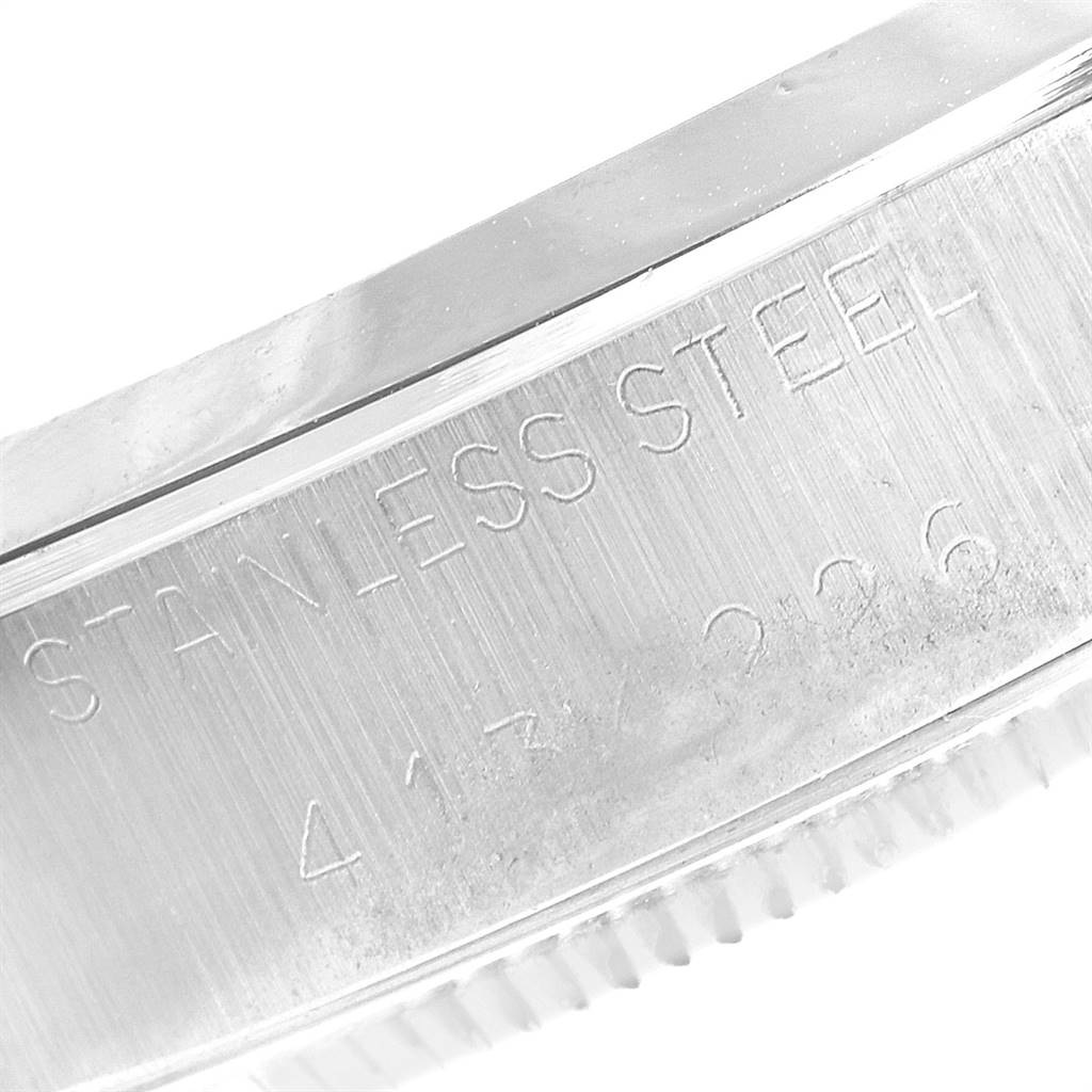 The image shows an extreme close-up of the side of the Rolex Vintage Collection 1002 Men's Stainless Steel Silver Dial 1002 Men's Stainless Steel Silver Dial model, highlighting the stainless steel engraving.