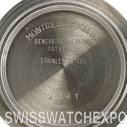 This image shows the stainless steel case back of a Tudor Submariner 90910 Men's Stainless Steel Black Dial 90910 Men's Stainless Steel Black Dial, displaying engraved text.