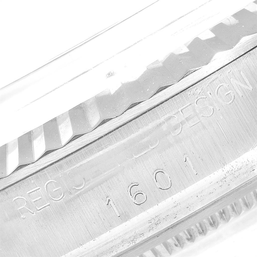 This image shows a close-up of the engraved bezel and case edge of the Rolex Vintage Collection 1601 Men's Stainless Steel Silver Dial 1601 Men's Stainless Steel Silver Dial model 1601.