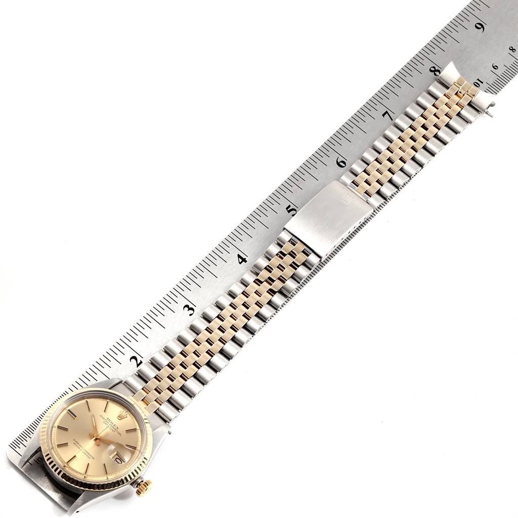 The image shows a Rolex Vintage Collection 1601 Men's Steel and Gold (two tone) Champagne Dial 1601 Men's Steel and Gold (two tone) Champagne Dial watch from an overhead angle, displaying the face and bracelet alongside a ruler.
