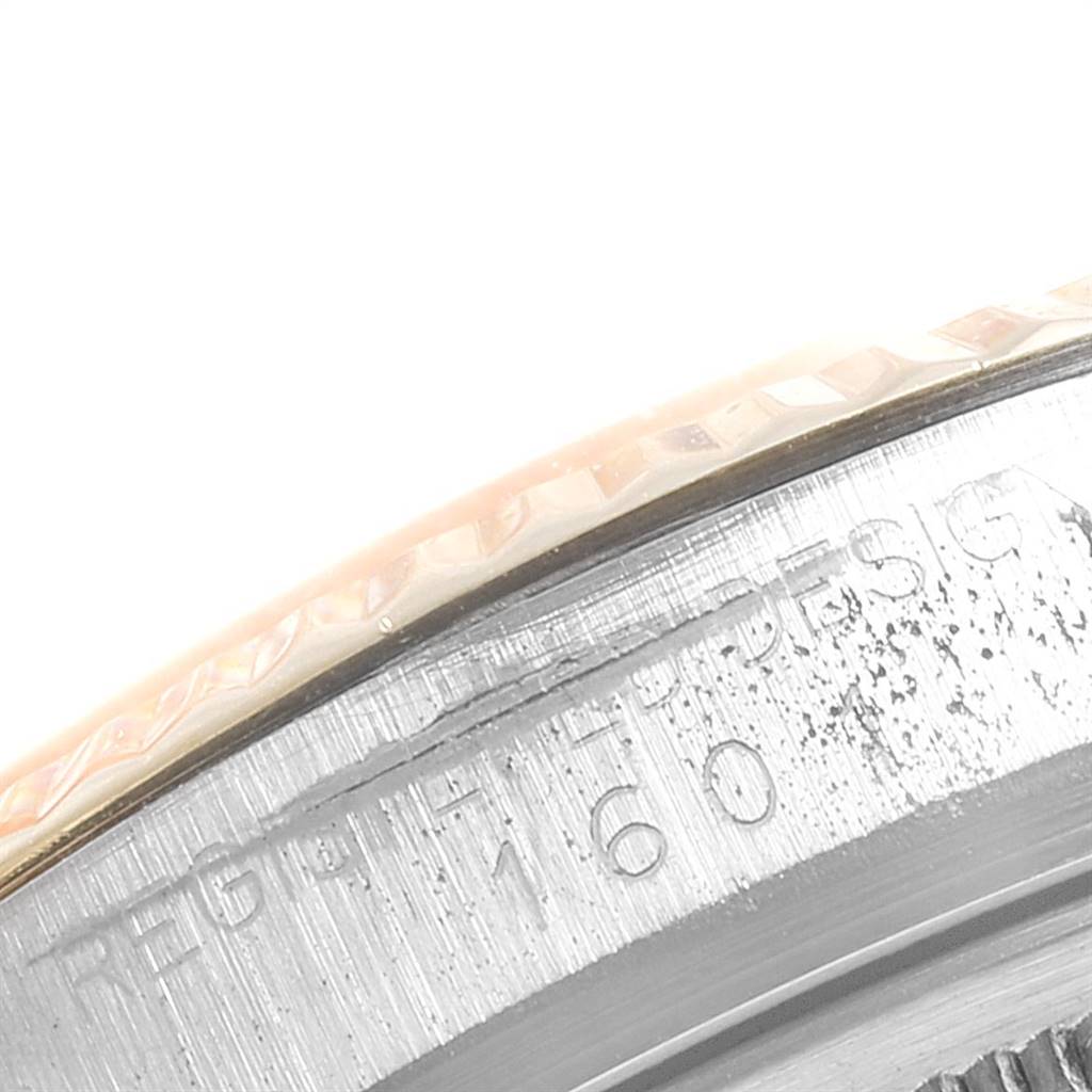 The image shows a close-up of the bezel and part of the case with engraved text on a Vintage Collection model by Rolex.
