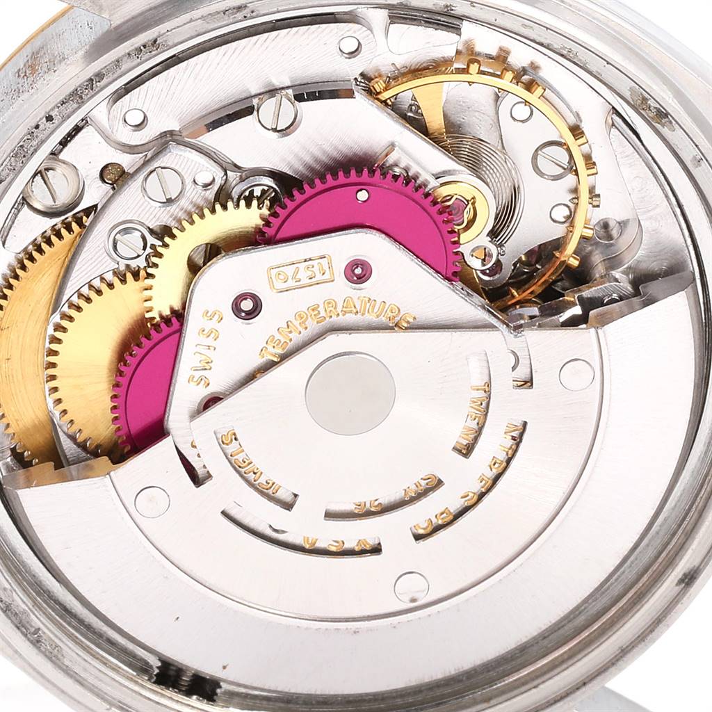 Close-up interior view of the Rolex Vintage Collection 1601 Men's Steel and Gold (two tone) Champagne Dial 1601 Men's Steel and Gold (two tone) Champagne Dial watch, showing gears and mechanical components.
