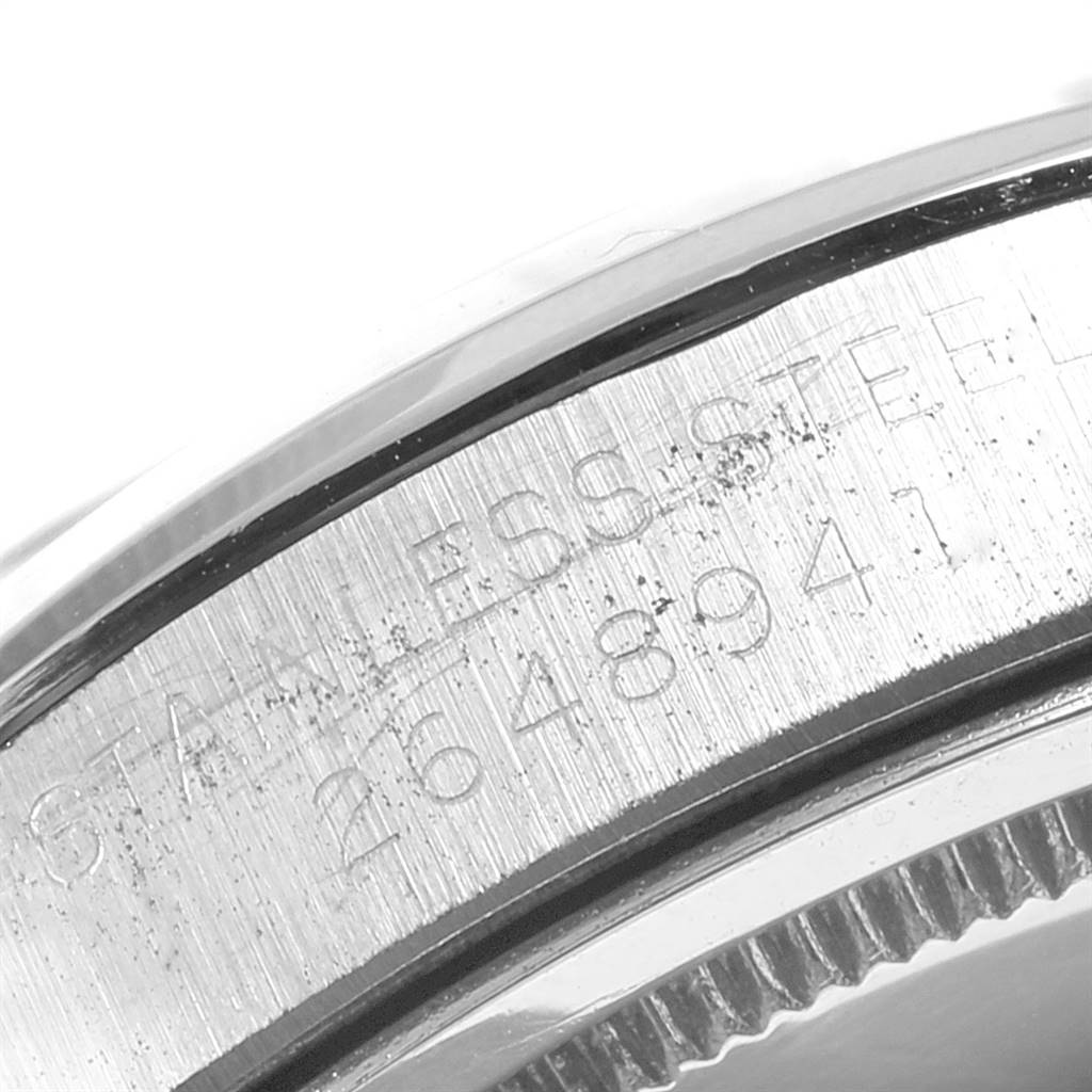 This image shows a close-up view of the case back rim of the Rolex Vintage Collection 6694 Men
s Stainless Steel Silver Dial 6694 Men
s Stainless Steel Silver Dial model watch, featuring its serial number and "STAINLESS STEEL" engraving.