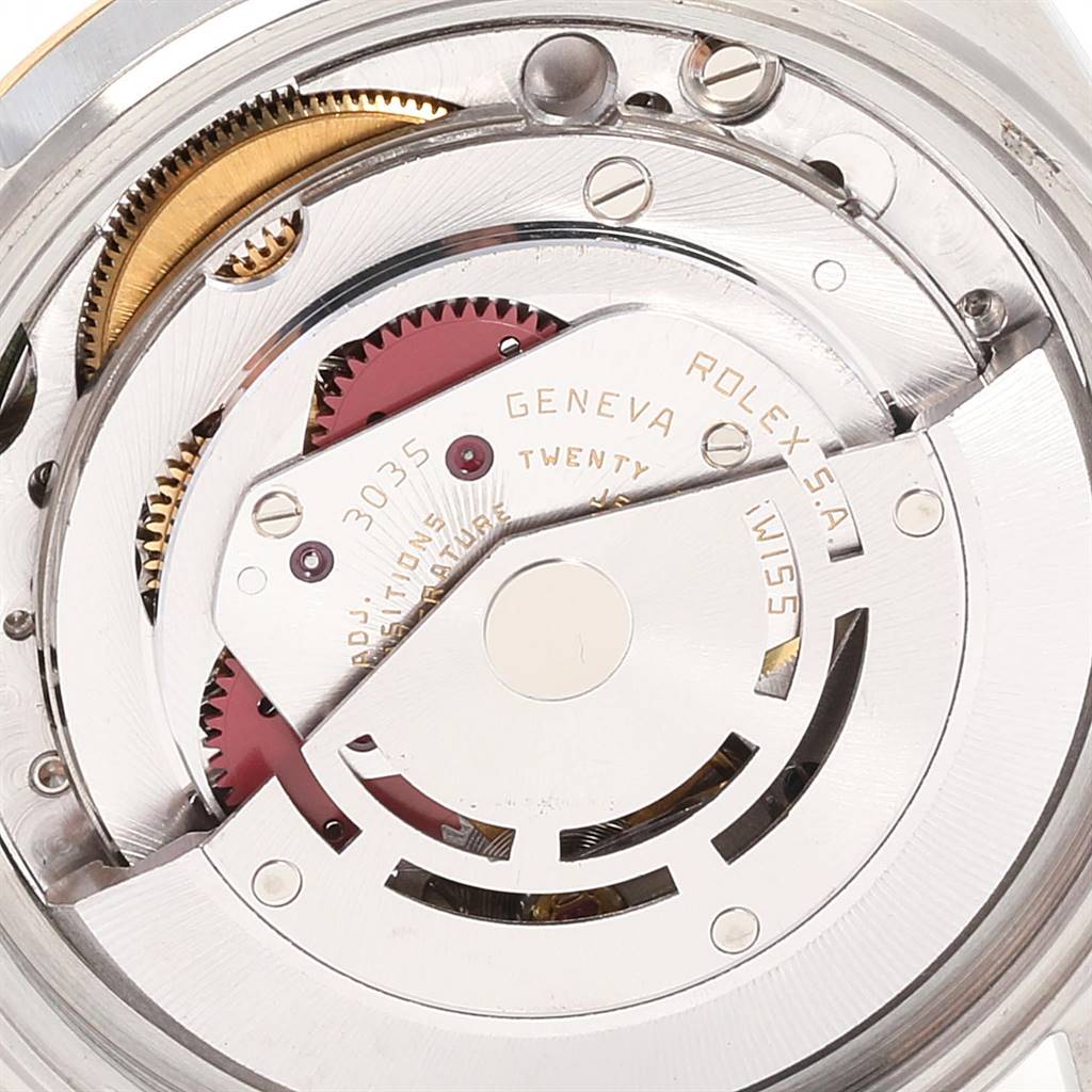 The image shows a close-up of the inner mechanism and gears of a Vintage Collection Rolex watch.
