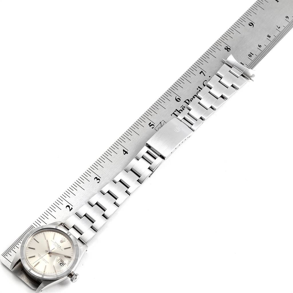 The image shows the full length of a Rolex Vintage Collection 1501 Men's Stainless Steel Silver Dial 1501 Men's Stainless Steel Silver Dial watch, including the face and bracelet, placed alongside a ruler.