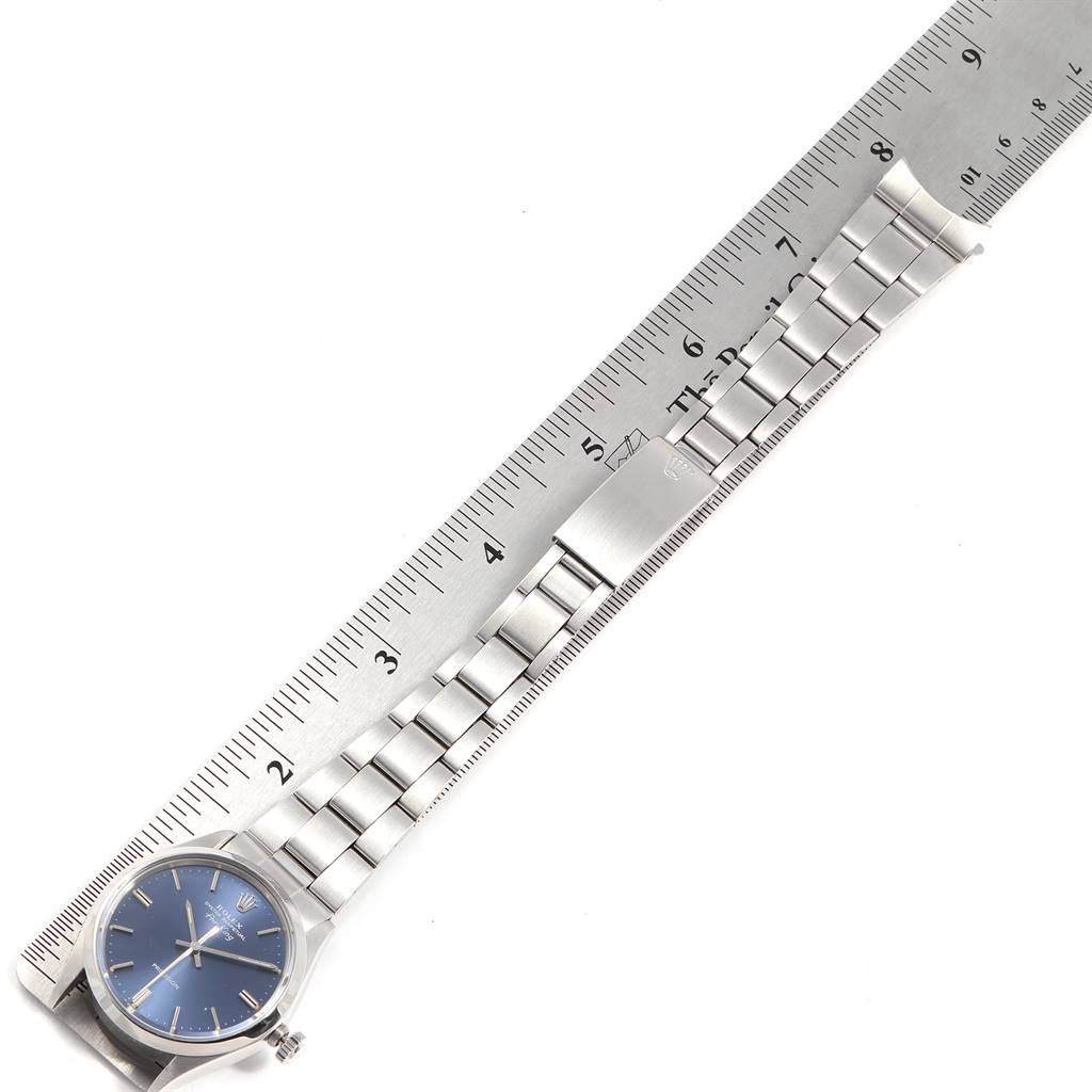 The image shows a Rolex Vintage Collection 5500 Men's Stainless Steel Blue Dial 5500 Men's Stainless Steel Blue Dial watch, viewed from above, displaying its face, bracelet, and clasp against a ruler.