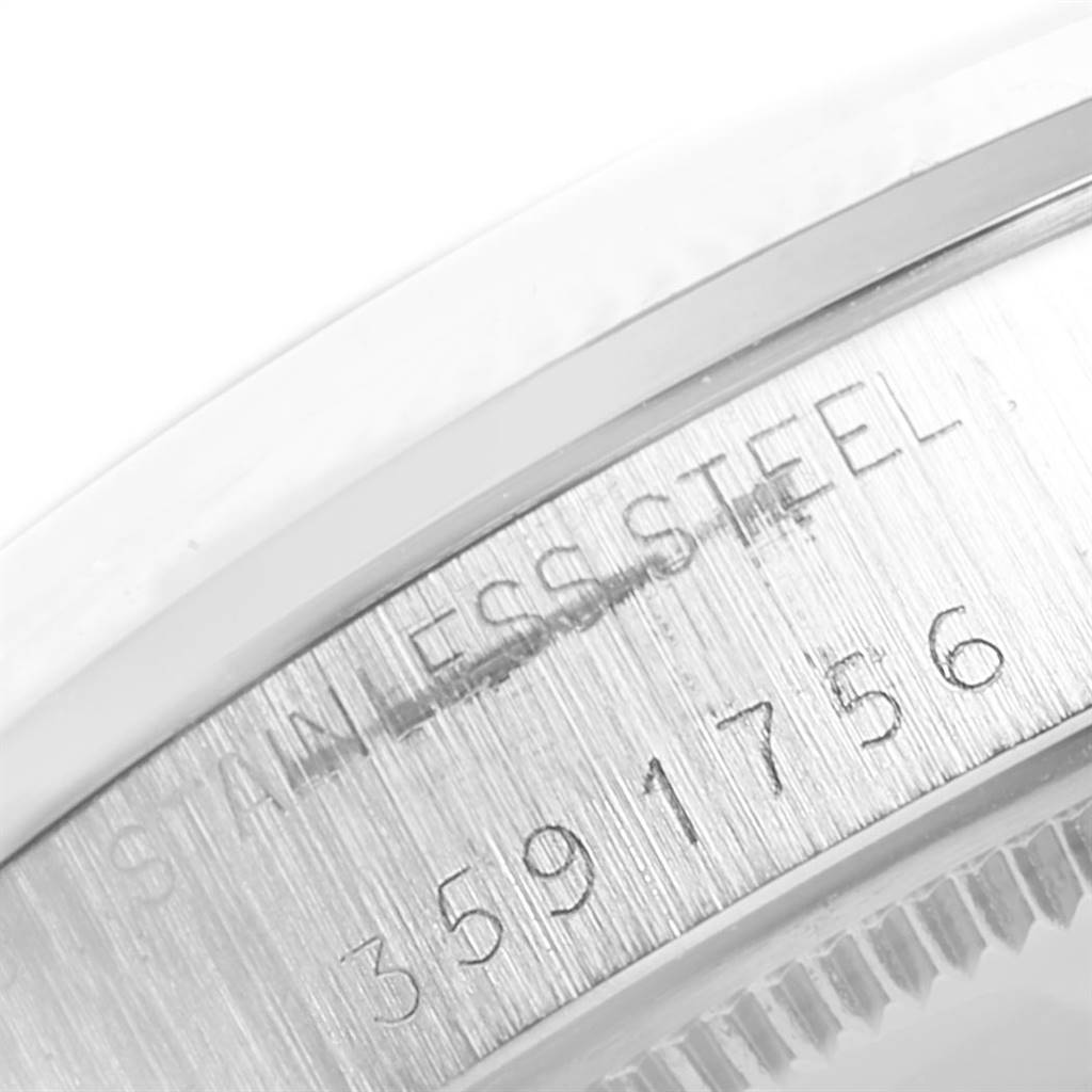 This image shows a close-up of the case side detailing the serial number and "Stainless Steel" engraving on a Rolex Vintage Collection 5500 Men's Stainless Steel Blue Dial 5500 Men's Stainless Steel Blue Dial model.
