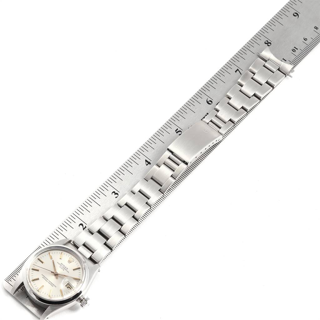 This image shows a Rolex Vintage Collection 1500 Men's Stainless Steel Silver Dial 1500 Men's Stainless Steel Silver Dial watch face and stainless steel bracelet next to a ruler for measurement.