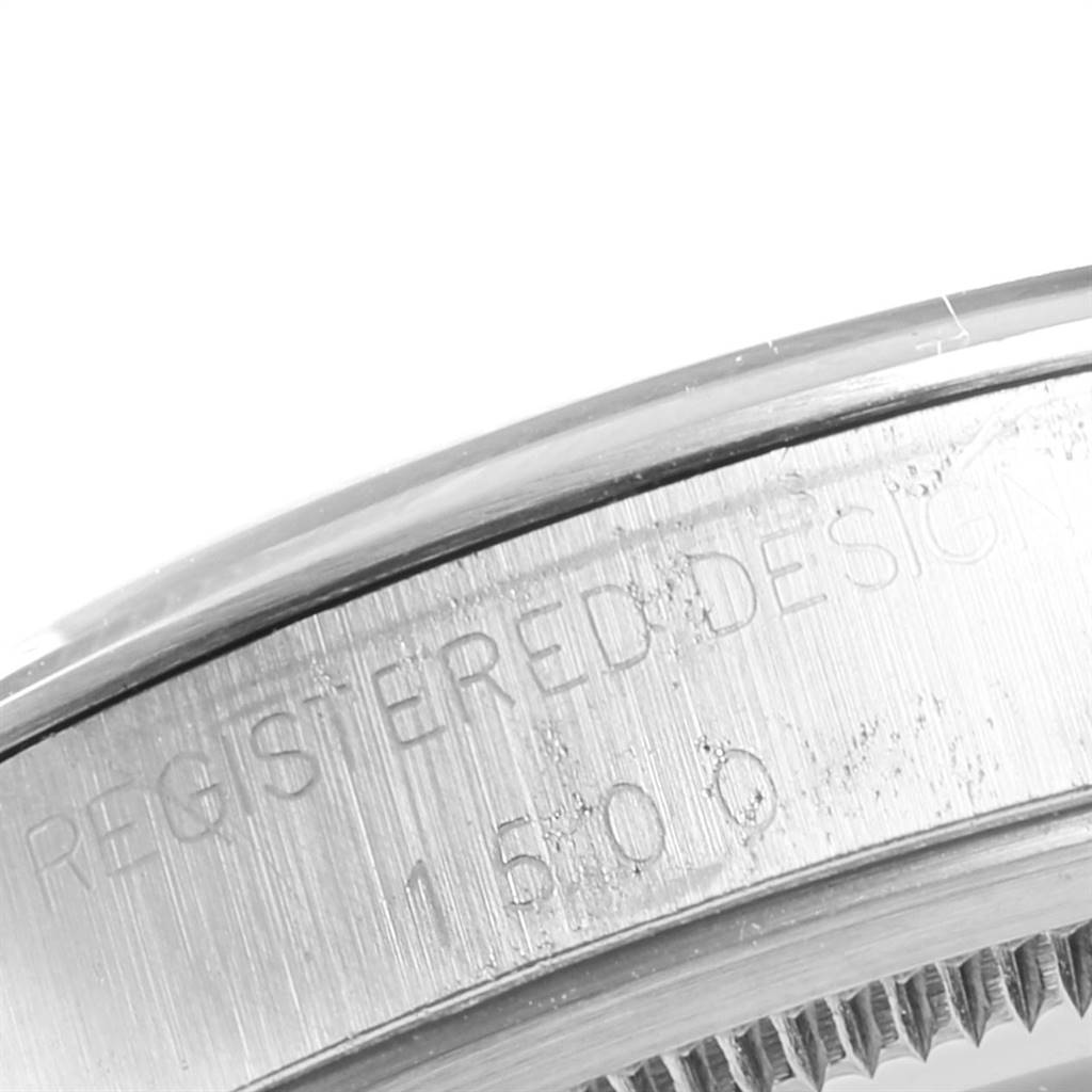 The image shows a close-up of the engraved serial number on the bezel of a Rolex Vintage Collection 1500 Men's Stainless Steel Silver Dial 1500 Men's Stainless Steel Silver Dial model watch.