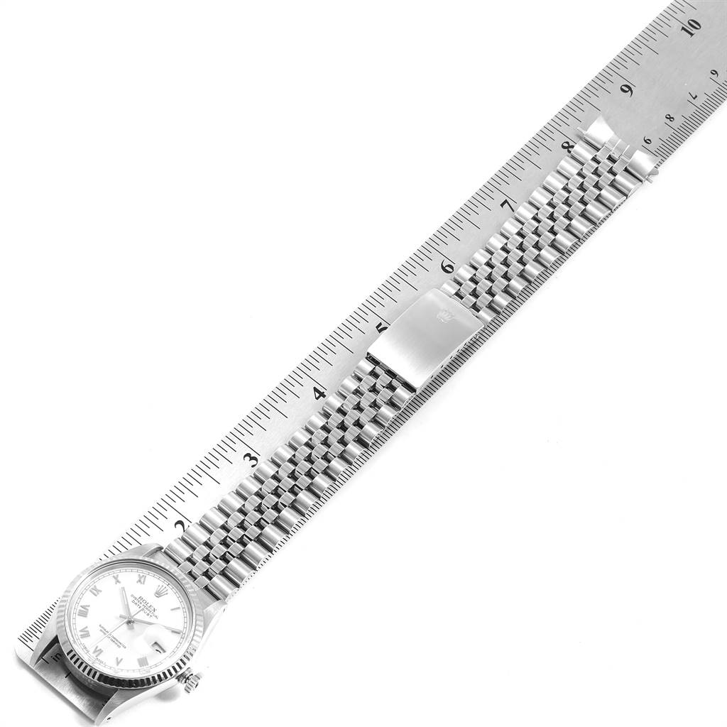 The Vintage Collection Rolex watch is shown flat with a ruler, featuring its dial and metal bracelet.