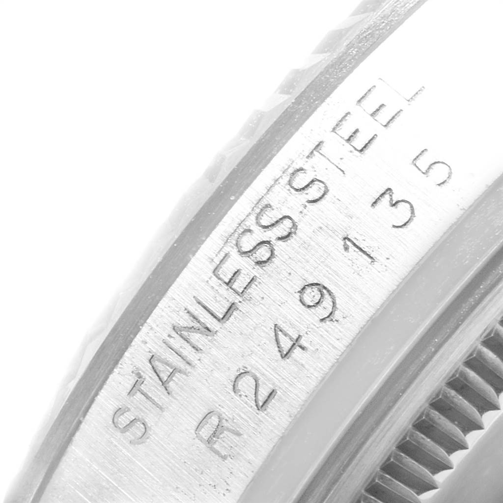 This image shows a close-up of the engraved stainless steel rim and bezel of a Rolex Vintage Collection 16014 Men's Stainless Steel White Dial 16014 Men's Stainless Steel White Dial watch.