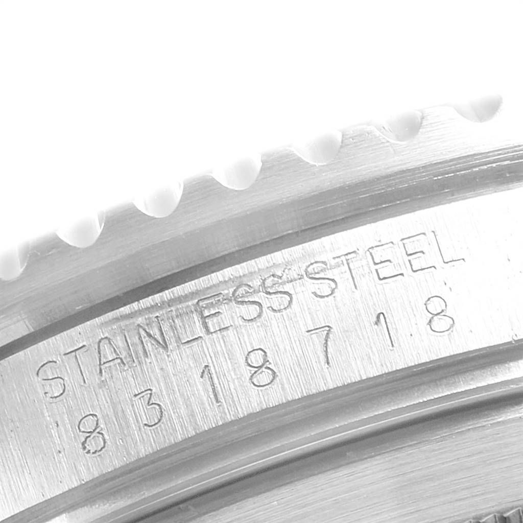 This image shows a close-up of the engraved serial number and the "STAINLESS STEEL" text on the side of a Vintage Collection Rolex watch case.