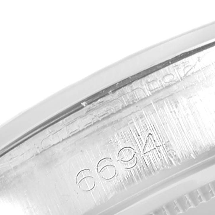 This image shows a close-up of the inner case engraving with the model number "6694" on a Rolex Vintage Collection 6694 Men's Stainless Steel Black Dial 6694 Men's Stainless Steel Black Dial watch.