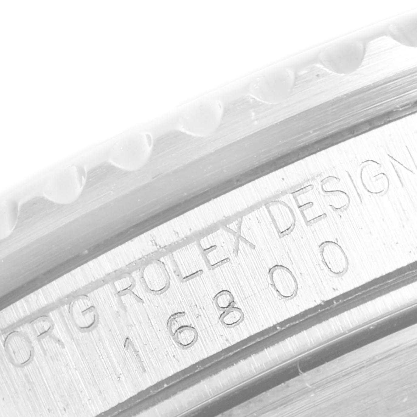 The image shows a close-up of the side case and bezel of a Rolex Vintage Collection 16800 Men's Stainless Steel Black Dial 16800 Men's Stainless Steel Black Dial model, featuring serial number engraving.