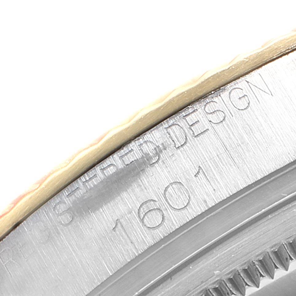This close-up image shows the engraved details on the casing and the edge of the bezel of the Rolex Vintage Collection 1601 Men
s Steel and Gold (two tone) Silver Dial 1601 Men
s Steel and Gold (two tone) Silver Dial model 1601.