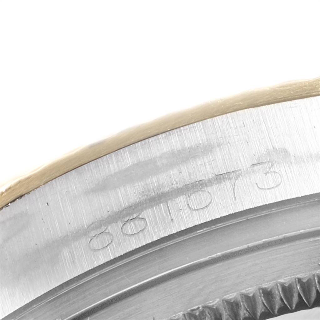 This close-up image shows the engraved side of the bezel and case of a Rolex Vintage Collection 1601 Men
s Steel and Gold (two tone) Silver Dial 1601 Men
s Steel and Gold (two tone) Silver Dial watch.