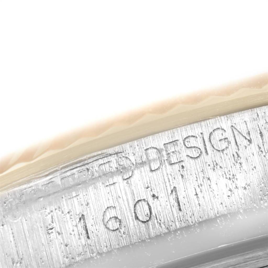 The image shows a close-up of the side of the Rolex Vintage Collection 1601 Men's Steel and Gold (two tone) Blue Dial 1601 Men's Steel and Gold (two tone) Blue Dial watch case with part of the engraving visible.