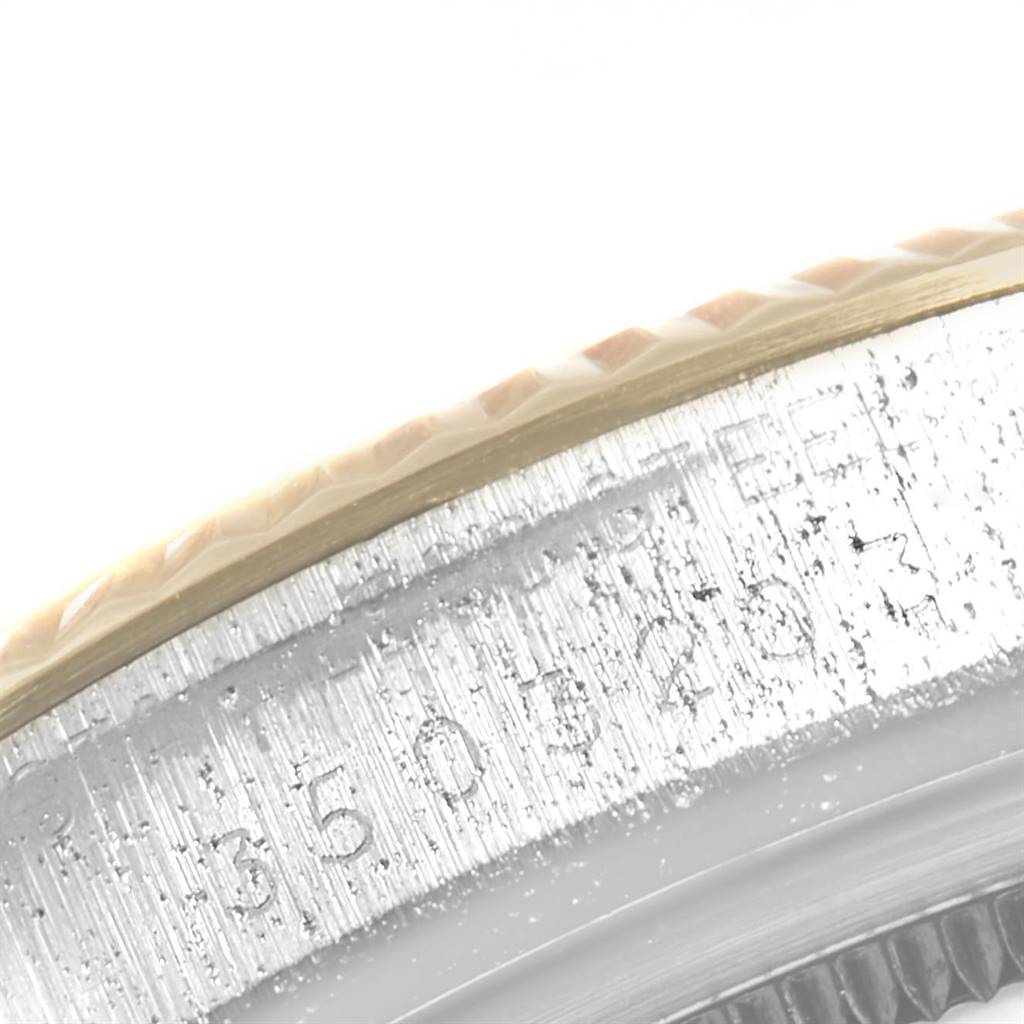 This close-up image shows the engraved serial number on the side of the bezel of a Vintage Collection model by Rolex.