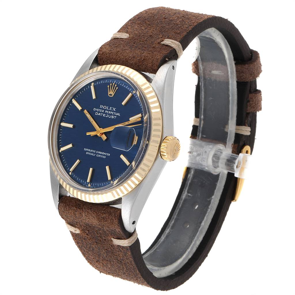 The Rolex Vintage Collection 1601 Men's Steel and Gold (two tone) Blue Dial 1601 Men's Steel and Gold (two tone) Blue Dial model watch is shown at a slight angle, featuring its gold-fluted bezel, blue dial, and brown suede strap.