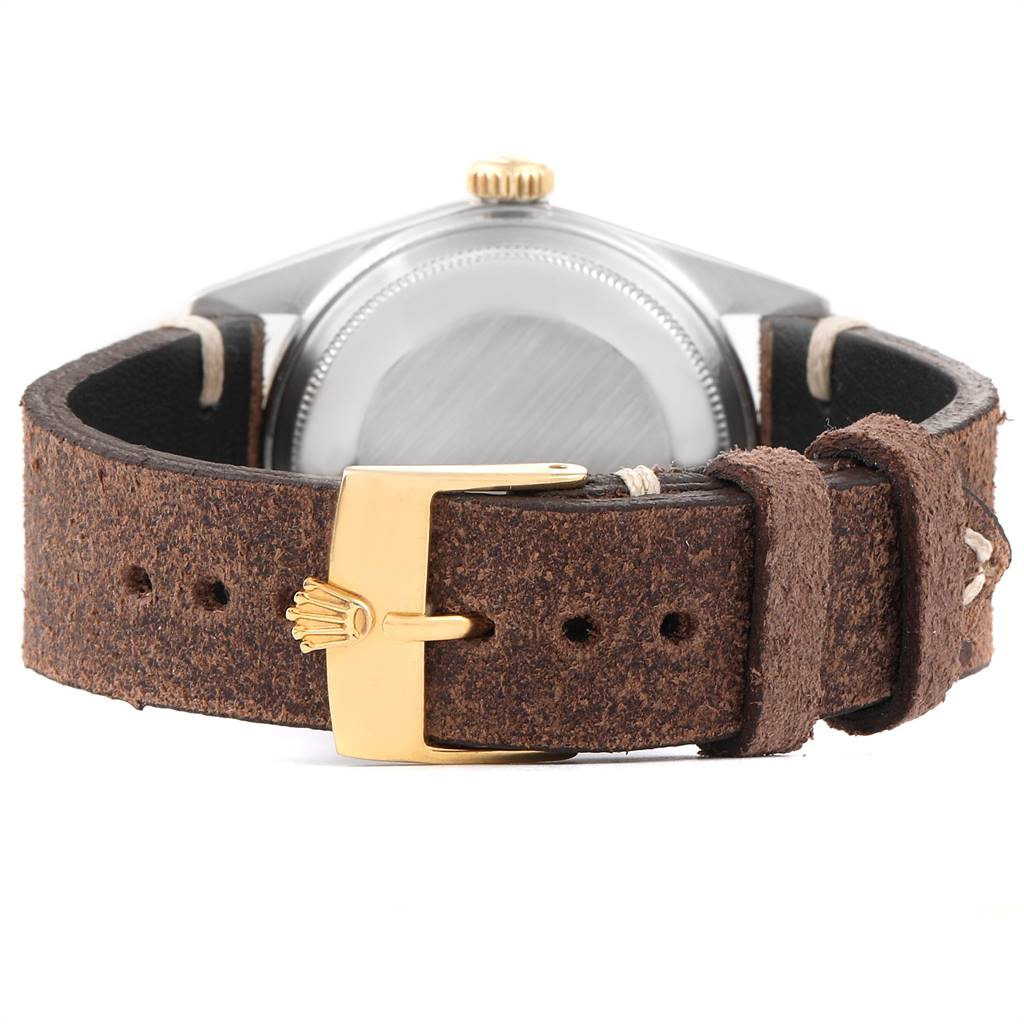 The image shows the back view of a Vintage Collection Rolex watch with a brown leather strap and a gold buckle.