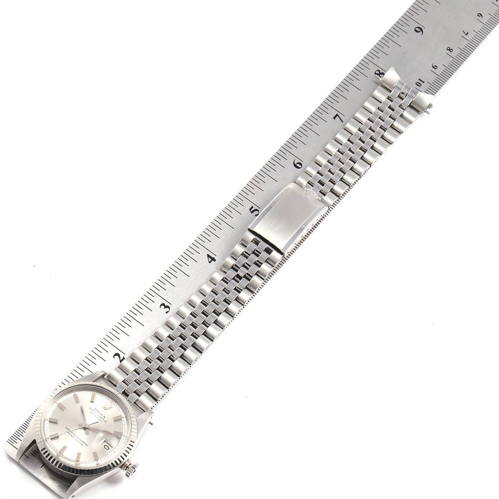 The Rolex Vintage Collection 1601 Men's Stainless Steel Silver Dial 1601 Men's Stainless Steel Silver Dial watch is shown from a top-down angle, highlighting the face, bezel, and full bracelet length against a ruler.